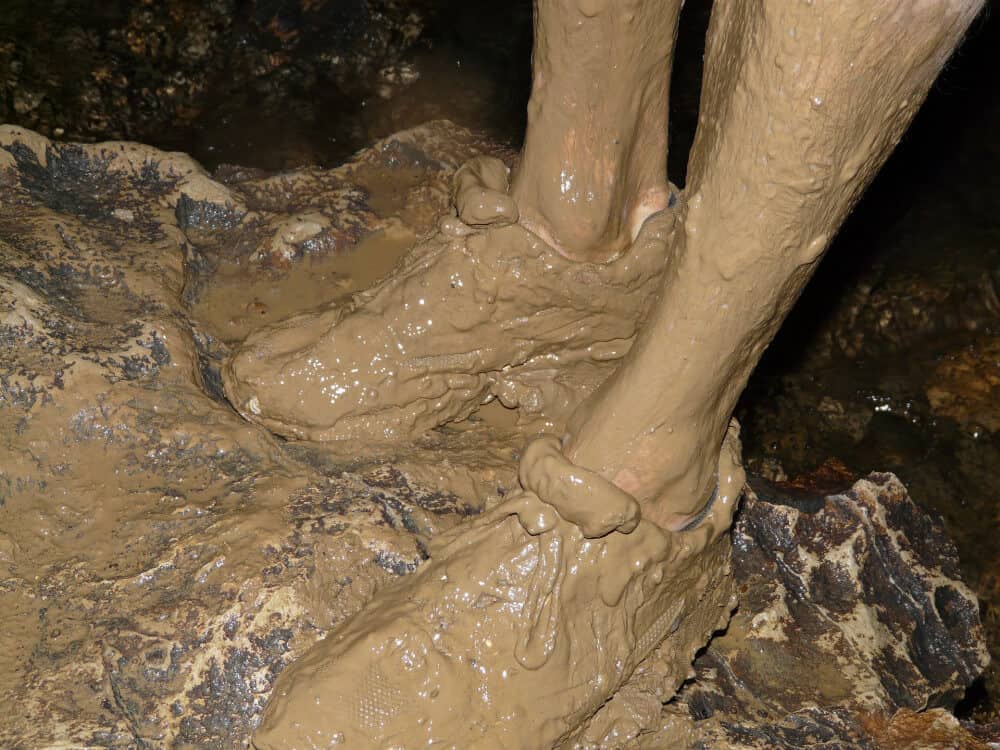Photo of muddy sneakers in cave
